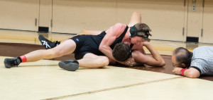 Louis Ternyik prepares to pin his opponent.