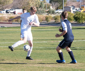 Elias Ricken maneuvers around a Lincoln Prep defender.