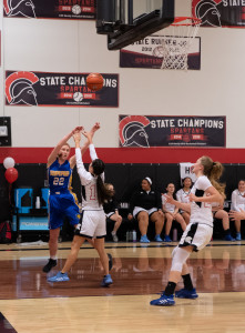 Grace Newman shoots over her Leading Edge opponent.