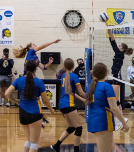 Spencer Bodow, far left, takes video during a varsity volleyball game.