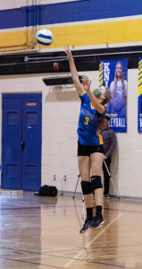 Julia Cady serves the ball.