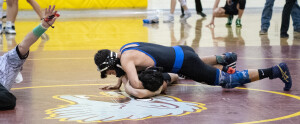 Gabe Ross prepares to pin his opponent.