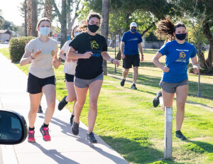 Coach Doc Hickernell works with the team's distance runners.